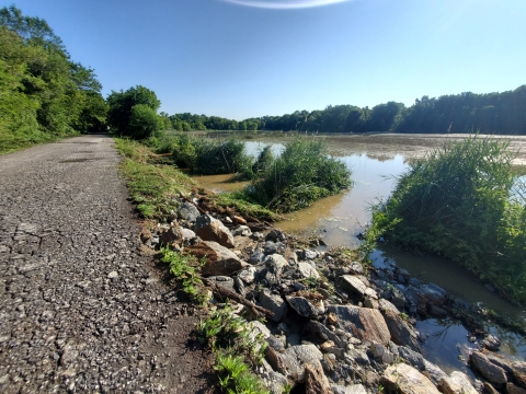 Erosion damage after Hurricane Isais. Flood waters washed away all the soil below the stairs and along the edge of the dike. Stairs were removed due to damage.