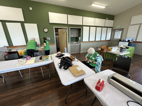 Ankeny Hill Nature Center volunteers preparing activities inside Gehlar Hall