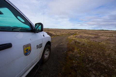 A FWS vehicle parked on a gravel road