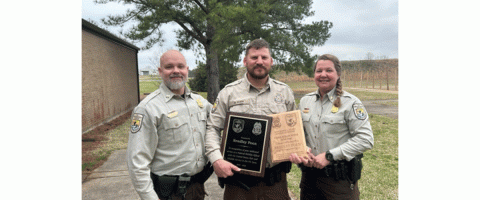 Bradley Poen poses for the camera showing his award