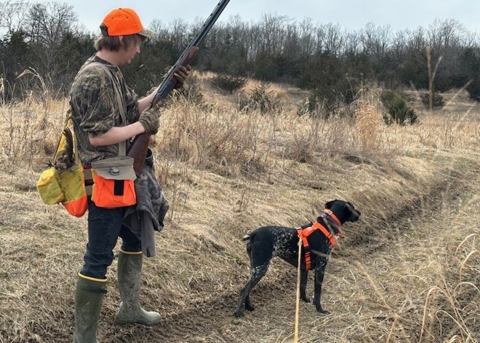 Hunter and dog during a pheasant hunt in Vermont 