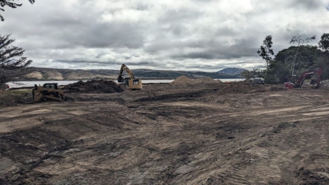 Heavy equipment grading the Chicken Ranch Beach Restoration project site on Tomales Bay in California