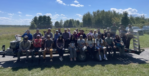 Large group of people sitting while posing for a photo