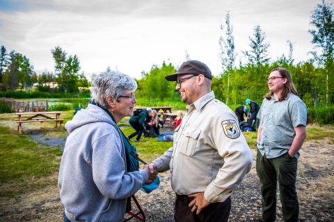 An attendee of a special event at a national wildlife refuge shakes the hand with the park ranger