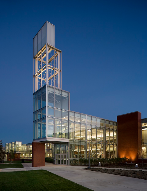 A building on a college campus illuminated by light at dusk