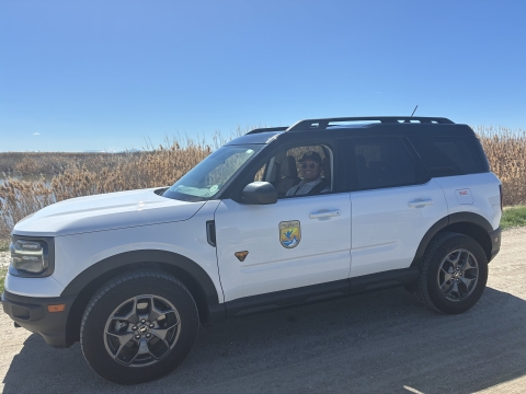 SUV with USWS shield on door on dirt road