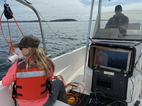 Biologist using an underwater camera to ground-truth drone eelgrass surveys.