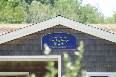 Blue welcome sign at over the shooting range