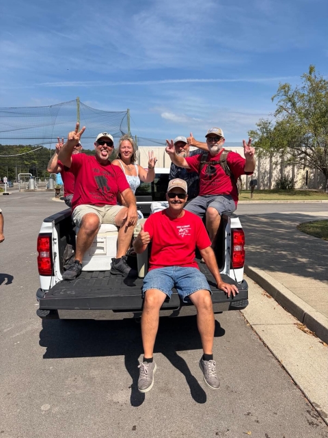 People smiling in truck bed