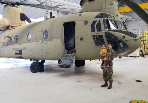 Story author, Addison Emerson, and his daughter pose in front of a Chinook helicopter.