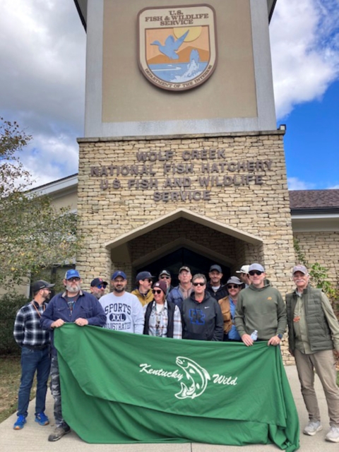 Group posing with banner