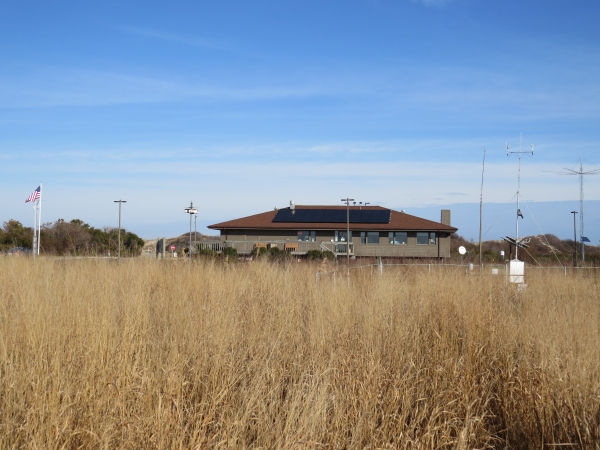 Grassy field with Visitor Center behind