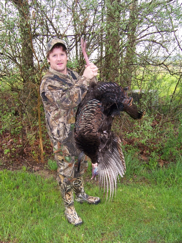 Hunter holding the turkey he harvested at Muscatatuck NWR
