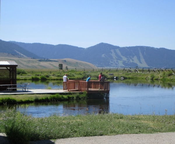 Image of visitors fishing from the pond deck