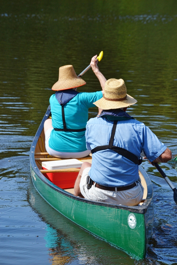 An image of two people paddling in a canoe.