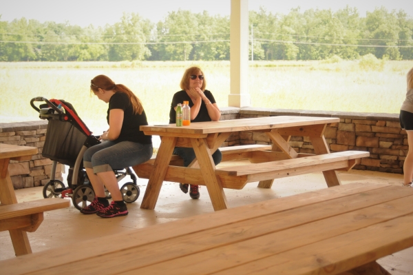 An image of two people at a picnic table.