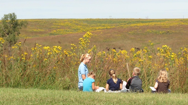 Students listening to an environmental education lesson on the prairie.