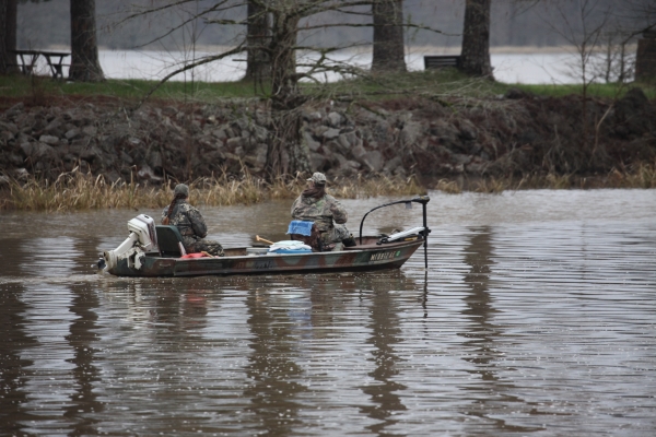 An image of two people in a boat going fishing.