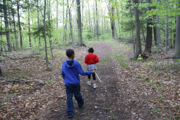 two kids hiking on a trail