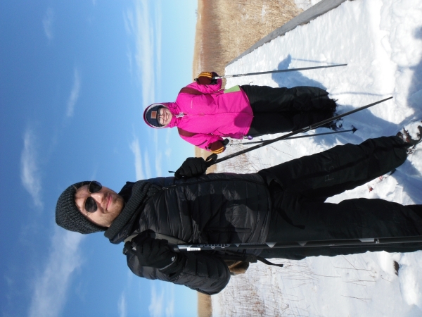 Two adults cross-country skiers pause for a photo on the trail