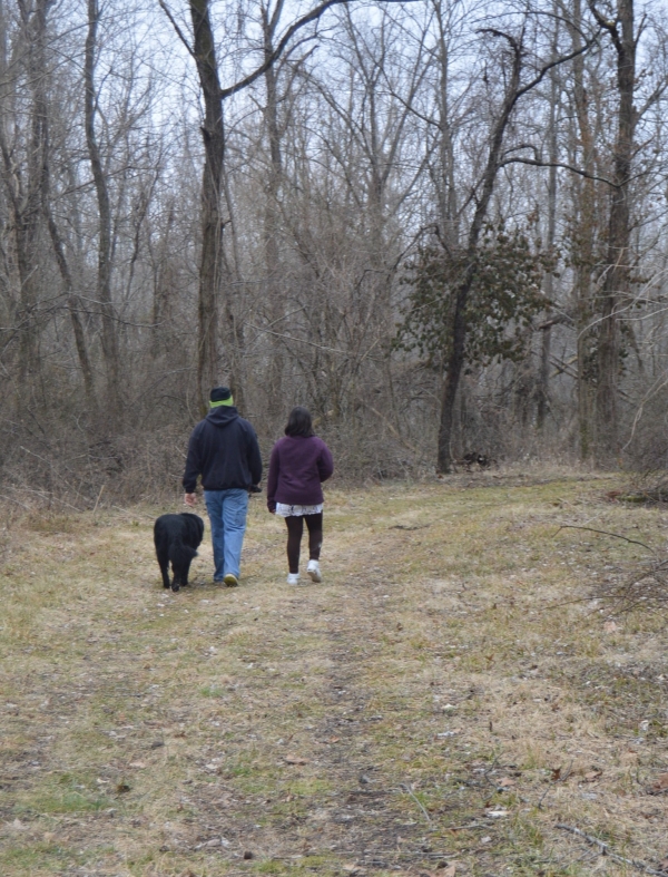 Visitors walking dog on trail
