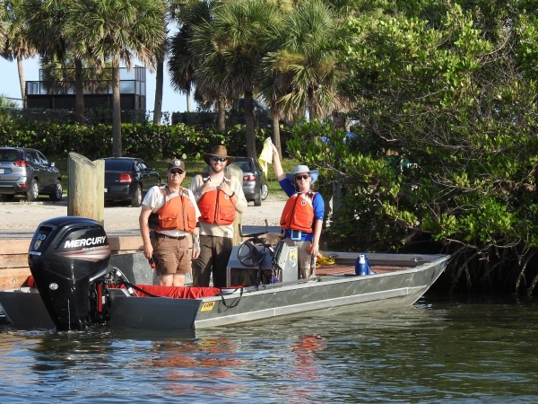 An image of refuge staff in a boat at the dock.