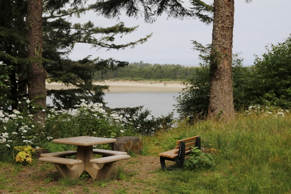 A bench and picnic table overlook Nestucca Bay