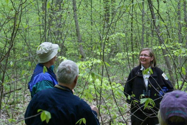 Refuge staff person talking to group in the woods
