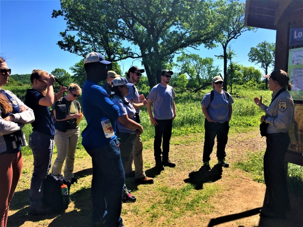 Park ranger speaks to a group while outdoors