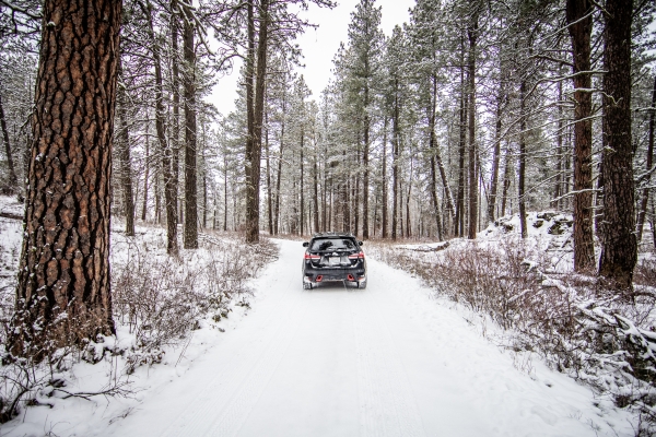 A car drives a snow covered auto tour route