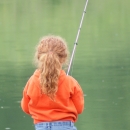 A small child fishing.