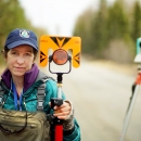 woman holding survey equipment