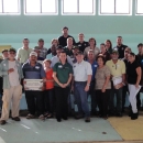 Group of twenty nine people standing in a group posing for the camera
