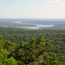 Lake Travis in the distance surrounded by ashe juniper trees