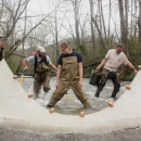 A team of biologists stretch a seine across a river.