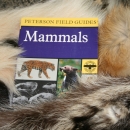 An image of a mammal book laying on top of fur examples.