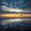 A sunset over Izembek Lagoon with a cloudy sky reflecting over the water