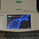 PCR machine with blue strand of DNA