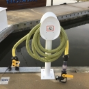 Pumpout station with yellow hose on dock. 