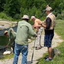A group of men fly fishing