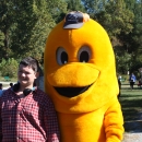 Student smiling next to Wolf Creek NFH's golden trout mascot, Goldie