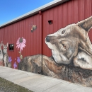 red wolf painted on a building with red background