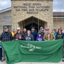 Group of anglers holding banner