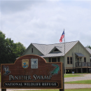 The Panther Swamp NWR Headquarters Office sign with the office in the background