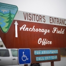 anchorage field office sign that's brown with logos in each corner