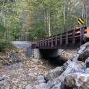 A bridge crosses a dry creek bed. 