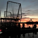 an electrified trawl net boat at sunset