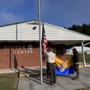 2 people raising flags
