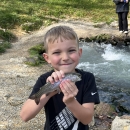 Boy holding rainbow trout