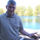 FWS employee holding mussels with river in background